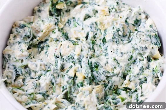 Close-up of baked Spinach & Artichoke Wonton Cups in a muffin tin