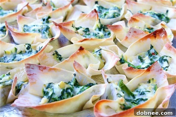 A close-up of a Spinach & Artichoke Wonton Cup ready to be served