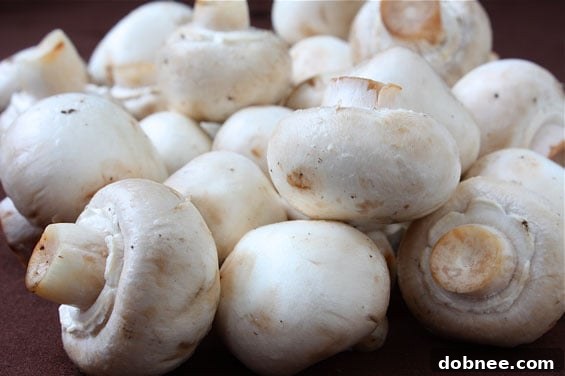 Platter of golden brown Bacon & Jalapeño Stuffed Mushrooms, ready to serve.