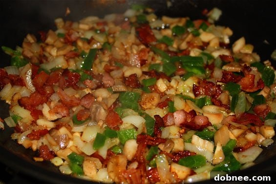 Stacked Bacon & Jalapeño Stuffed Mushrooms with fresh parsley garnish.