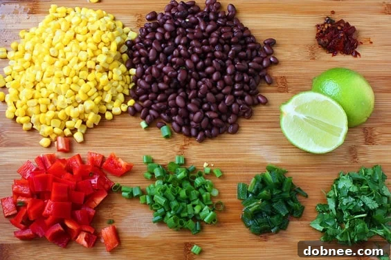 Close-up of the Corn & Black Bean Quinoa Salad, showcasing the texture of quinoa, corn kernels, and black beans mixed with dressing.