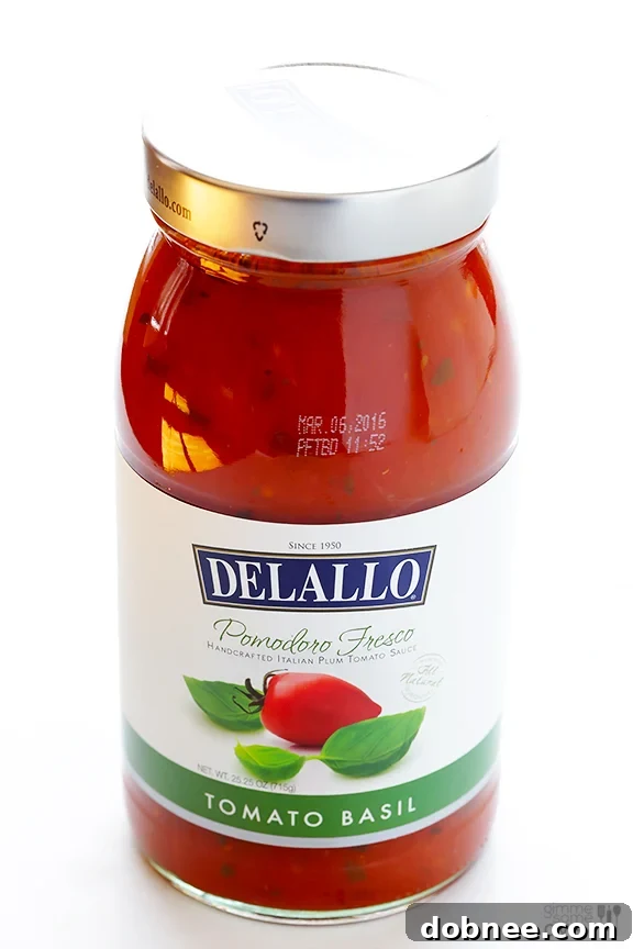 Layered Chicken Parmesan Baked Ziti showing pasta, chicken, marinara, and cheeses.