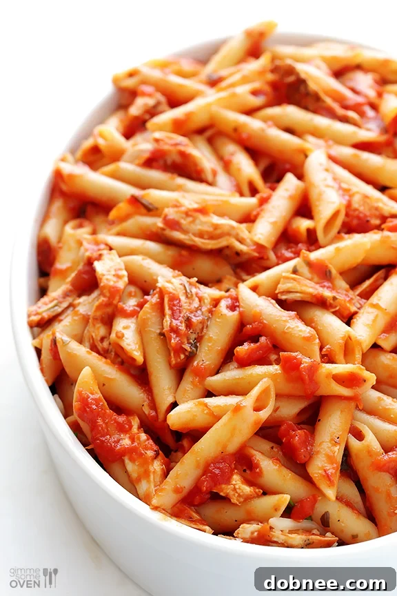 Close-up of Chicken Parmesan Baked Ziti, showcasing the melted cheese and pasta.