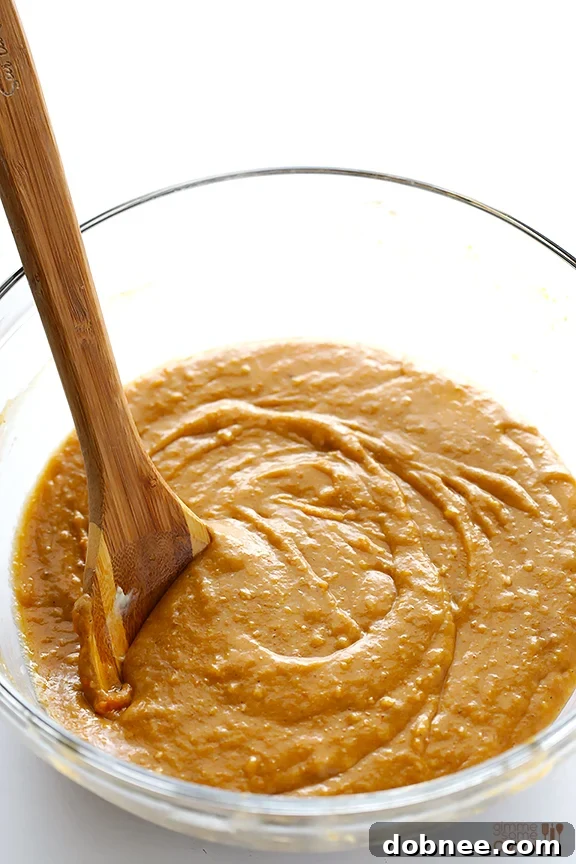 Mixing the pumpkin bread batter in a single bowl, showcasing the ease of preparation