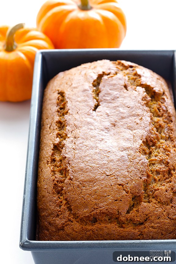 Smooth, spiced pumpkin bread batter poured into a loaf pan, ready for the oven