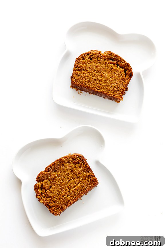 Slices of warm Coconut Oil Pumpkin Bread ready to be served on a rustic board