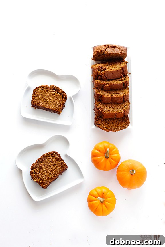 Serving Coconut Oil Pumpkin Bread with decorative mini pumpkins for a festive touch