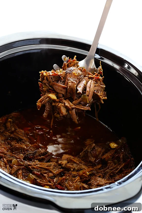 Slow cooker filled with beef chuck roast and barbacoa ingredients before cooking.