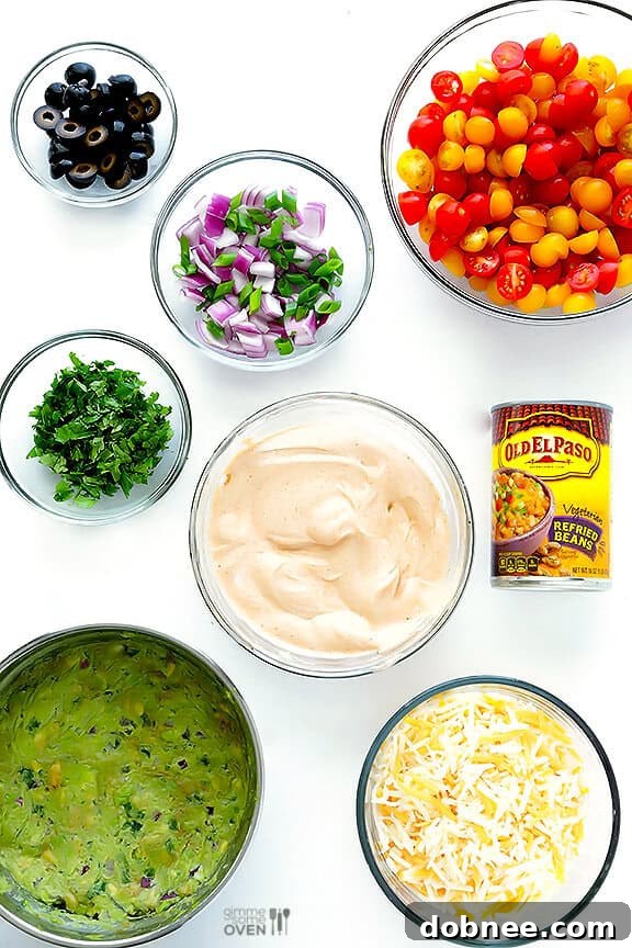 Close-up of the beautifully layered 7 Layer Dip, showcasing fresh ingredients and vibrant colors.