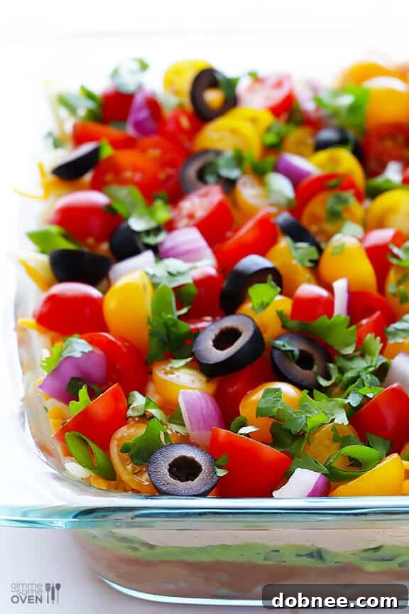 Fresh 7 Layer Dip in a shallow serving dish, ready for a crowd.