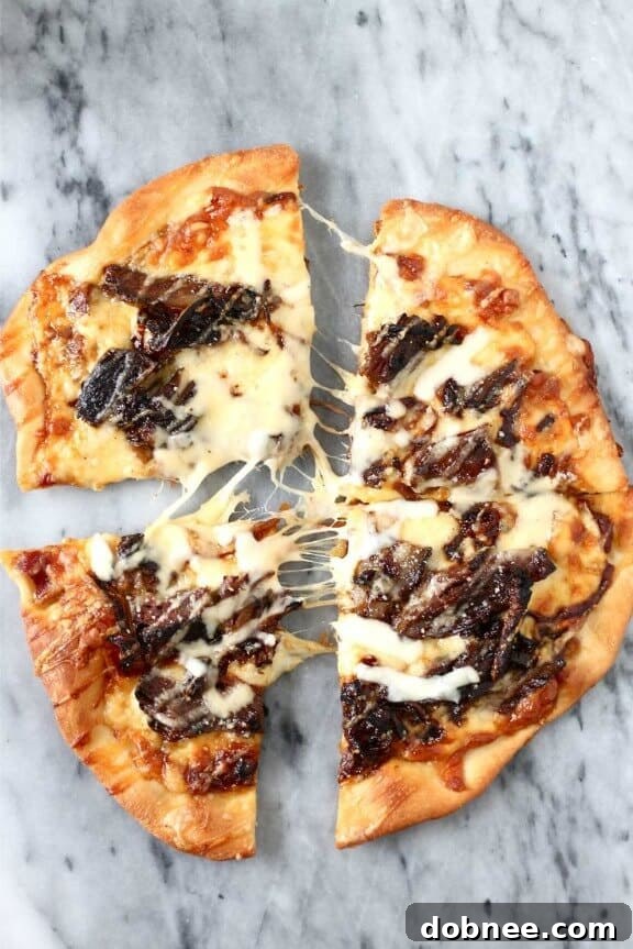 Short Rib Pizza with Caramelized Onions and a Smoked Gouda Cream Sauce, a rich and indulgent fall pizza.