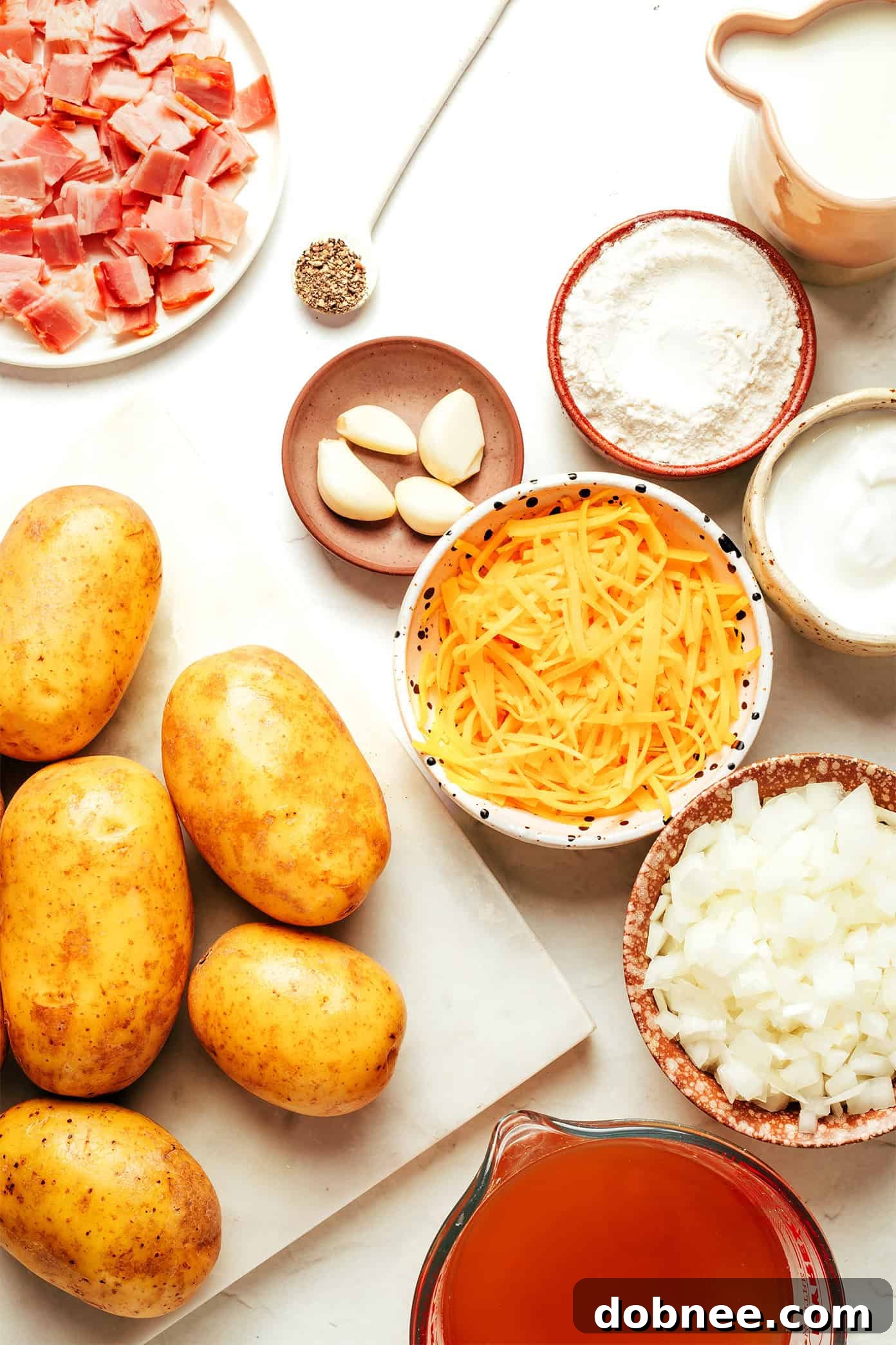 Close-up of a bowl of creamy potato soup, garnished with fresh herbs and cheese.