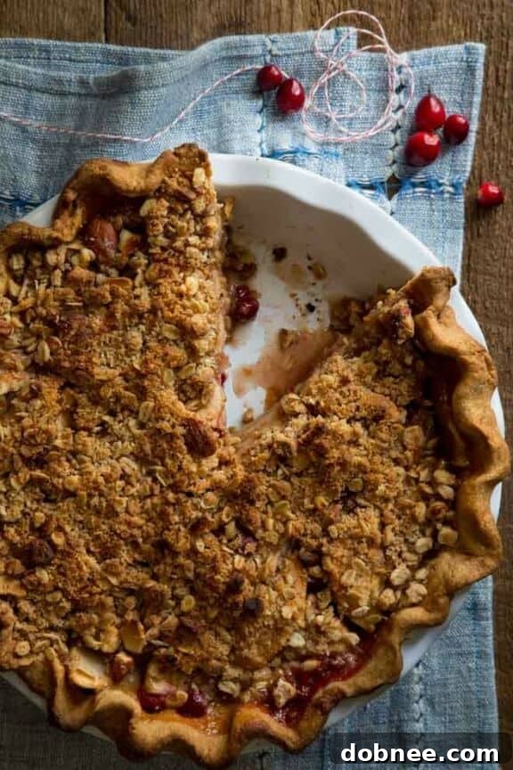 Rustic Cranberry Maple Apple Crumb Pie with a golden topping
