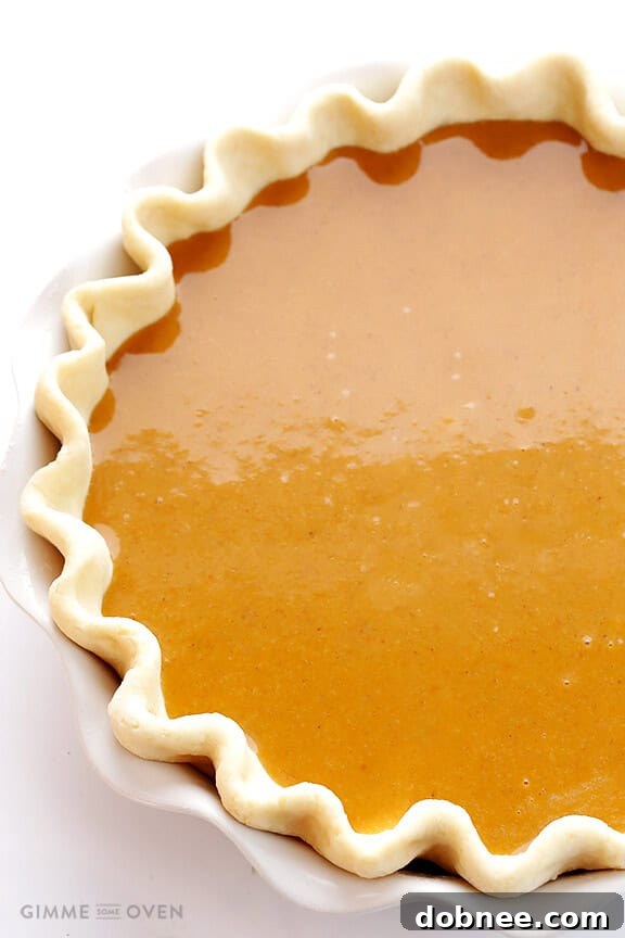 The Bourbon Pumpkin Pie baking in the oven, its crust golden and filling setting beautifully, filling the kitchen with enticing aromas.