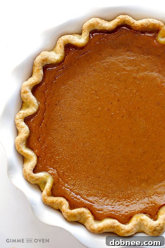 The freshly baked Bourbon Pumpkin Pie, cooling on a wire rack, its rich color and inviting scent promising a delightful treat.