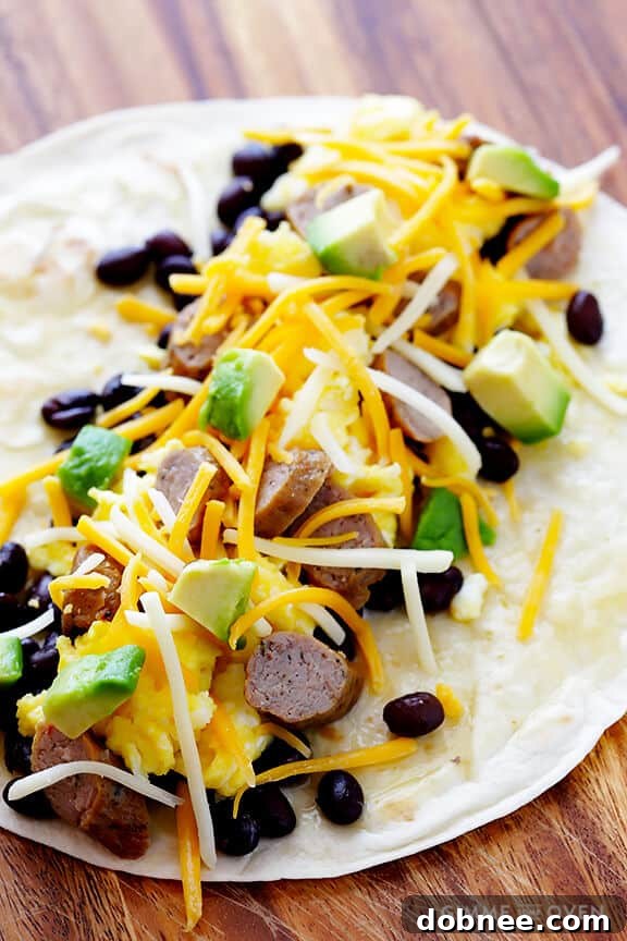 Rise & Shine Enchiladas 4 Assembling Breakfast Enchiladas with a focus on fresh, high-quality ingredients like scrambled eggs, sausage, and vibrant avocado slices.