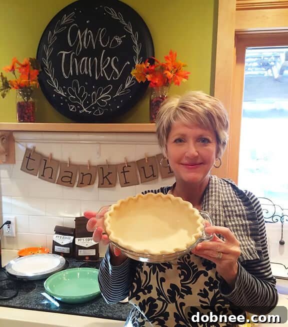 Mastering Non-Shrinking Pie Crusts Every Time 3 A beautifully crimped pie crust, showcasing expert technique to prevent shrinkage and achieve a perfect, golden-brown edge.