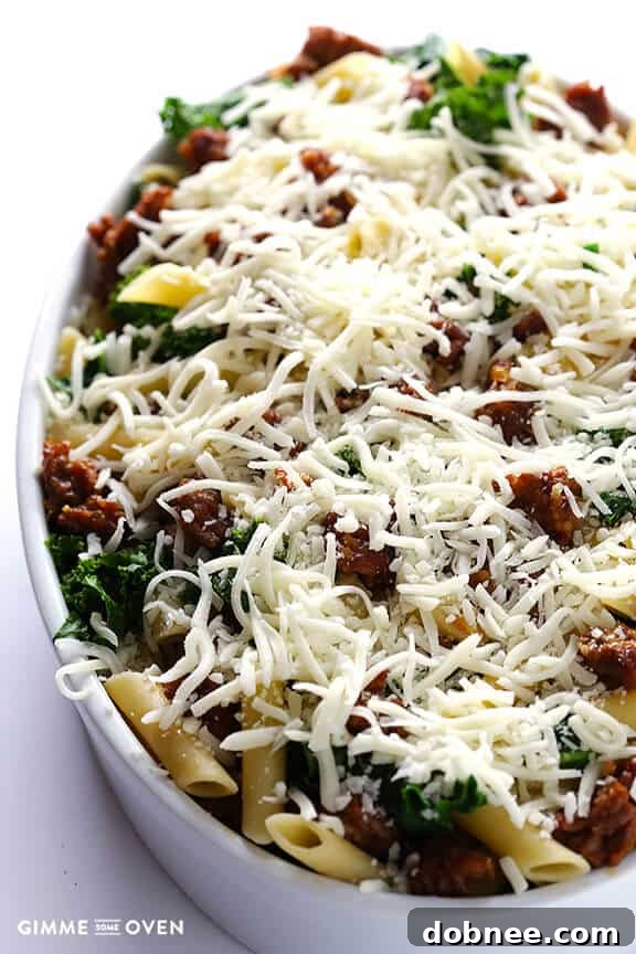 Mixing cooked pasta with Italian sausage, garlic, and kale for baked ziti