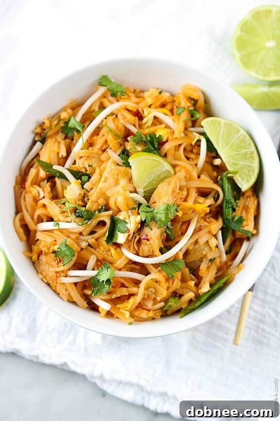 Authentic chicken pad Thai, featuring stir-fried rice noodles, tender chicken, and crushed peanuts.