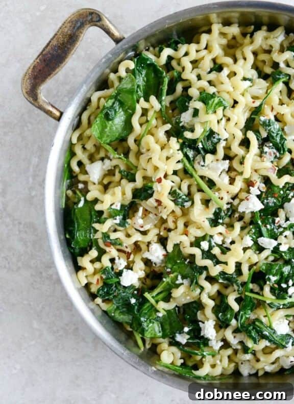 A creamy pasta dish featuring caramelized shallots, fresh spinach, and tangy goat cheese, enveloped in a garlic butter sauce.