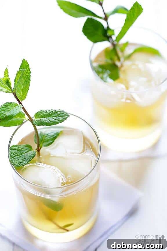 Refreshing Sparkling Ginger Mint Julep with mint sprig and ginger slice