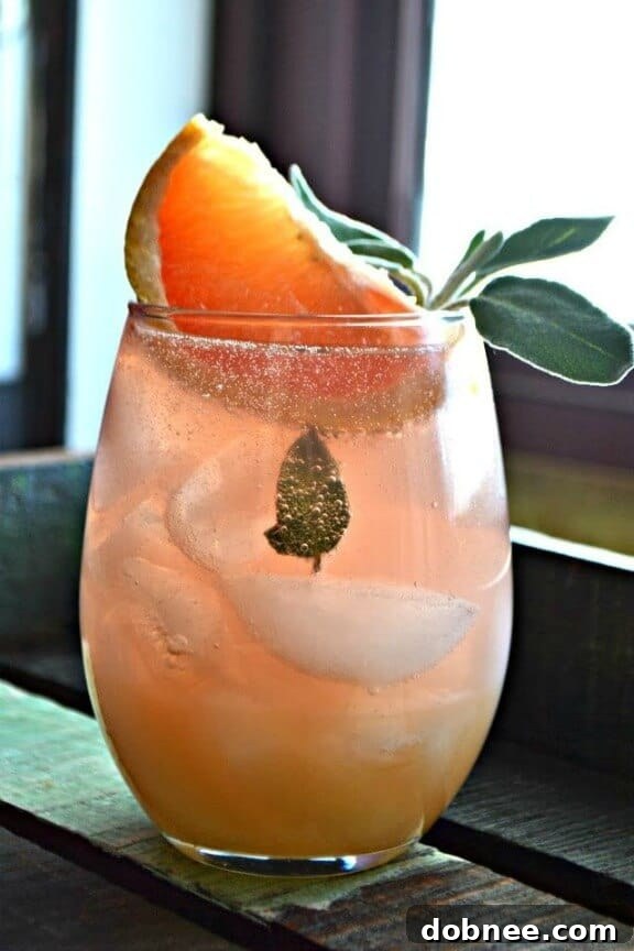 Bright Grapefruit and Sage Mimosa cocktail garnished with sage