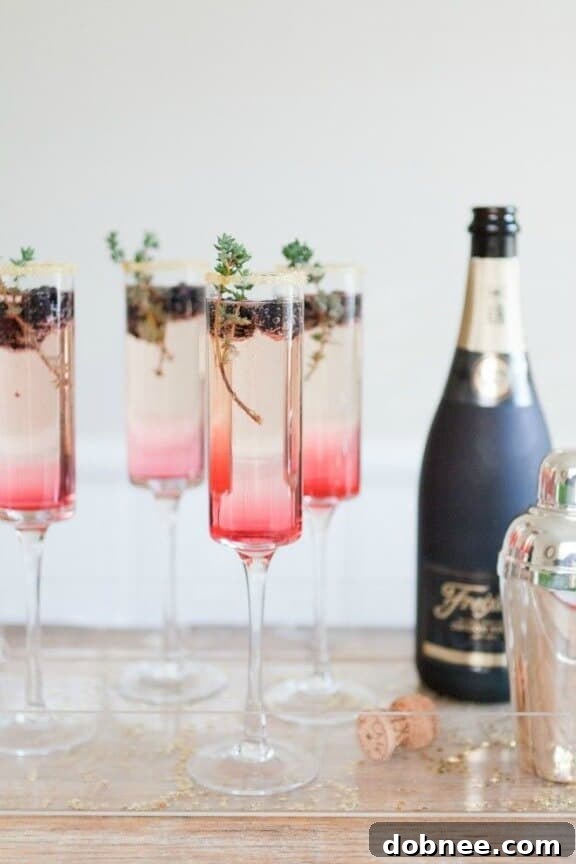 Elegant Blackberry Thyme Sparkler cocktail garnished with fresh thyme