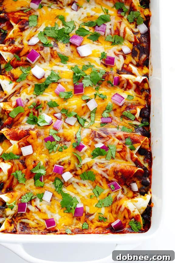 Ready-to-Serve Enchiladas A full tray of glistening BBQ Chicken Enchiladas, garnished generously with fresh cilantro and finely diced red onions, ready to be served