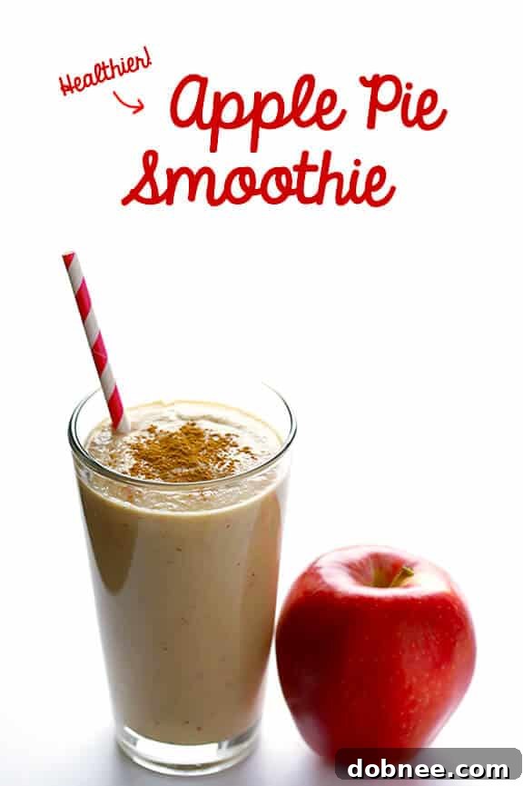 A vibrant and appealing Apple Pie Protein Smoothie, presented in a clear glass on a rustic wooden table, garnished with a dash of cinnamon. The image emphasizes the smoothie's freshness and inviting texture.