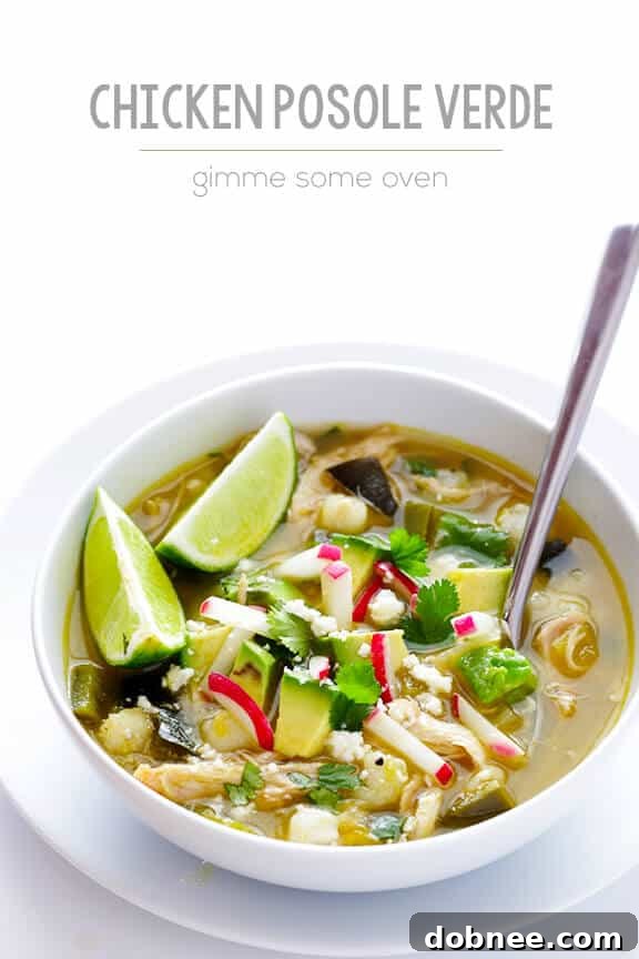 A large pot of Easy Chicken Posole Verde simmering on the stove, ready to be served.