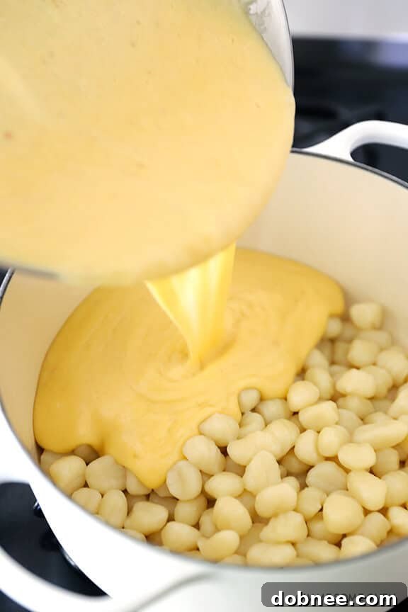 Ingredients for Gnocchi Mac and Cheese sauce, including grated cheeses and milk