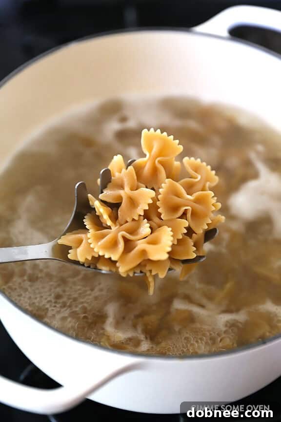 Whole wheat bow-tie pasta ready to be tossed with the creamy sauce