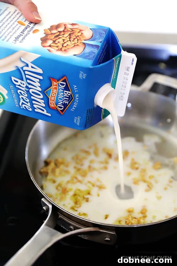 Close-up of garlic being sautéed for the creamy pasta sauce