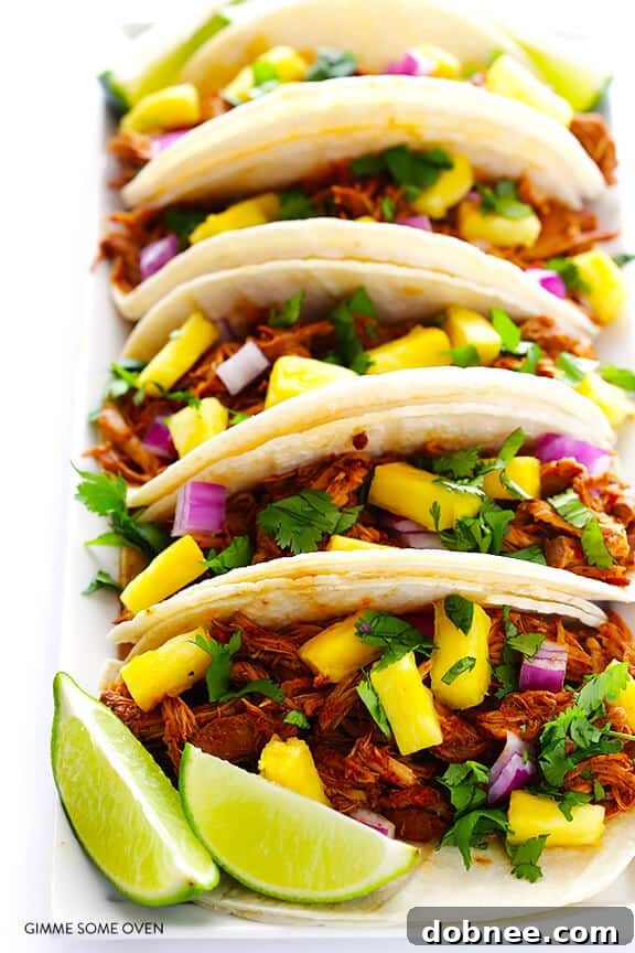 Plated Slow Cooker Tacos Al Pastor with fresh toppings
