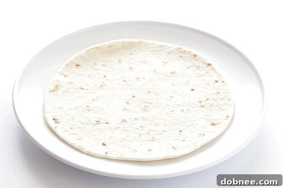 Effortless 5-Ingredient Chicken Guacamole Taquitos 4 Assembling Chicken Guacamole Taquitos: Ingredients lined up in tortillas