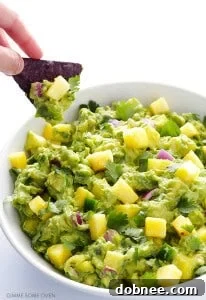 Vibrant Pineapple Guacamole in a bowl, garnished with fresh cilantro and pineapple pieces.