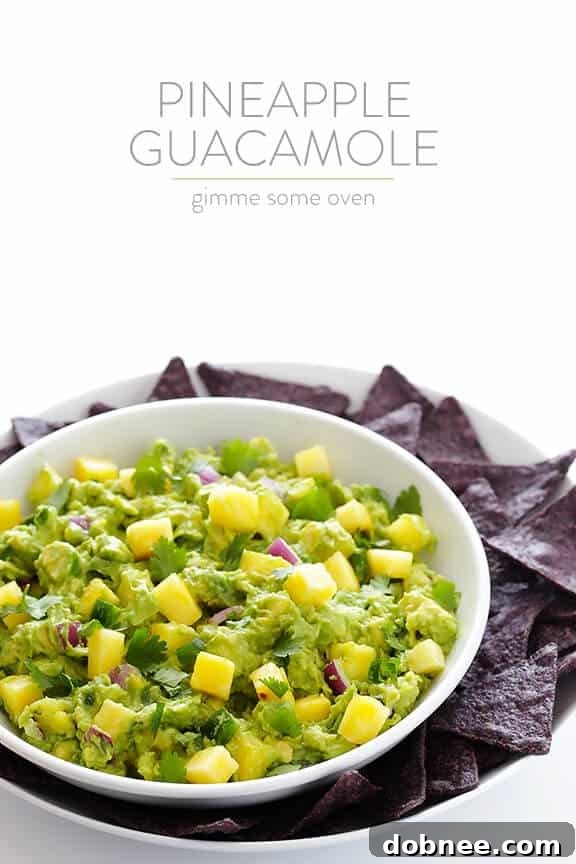 A beautifully arranged serving of Pineapple Guacamole with Garden of Eatin' blue corn tortilla chips, garnished with cilantro.