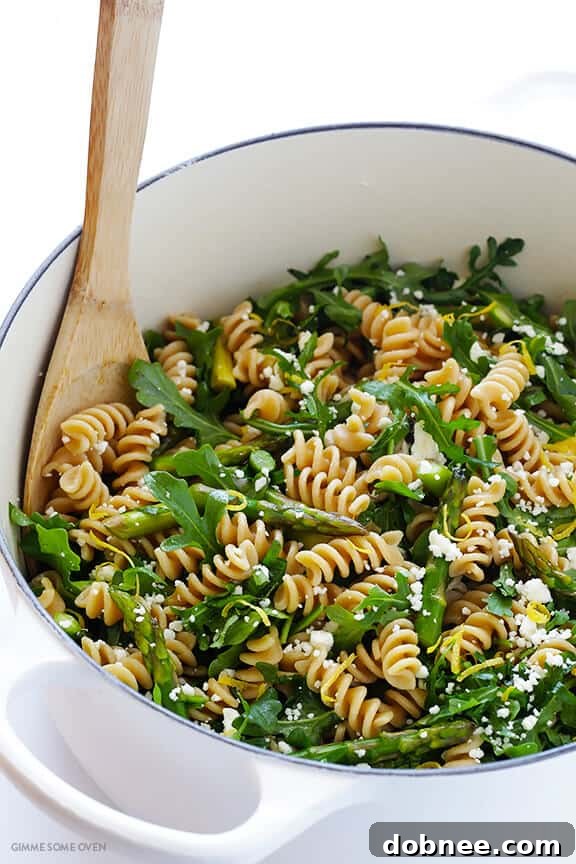Combining fresh ingredients for Asparagus and Arugula Pasta Salad
