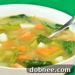 A small bowl of Spring Vegetable Minestrone, garnished with fresh herbs and a hint of cheese.
