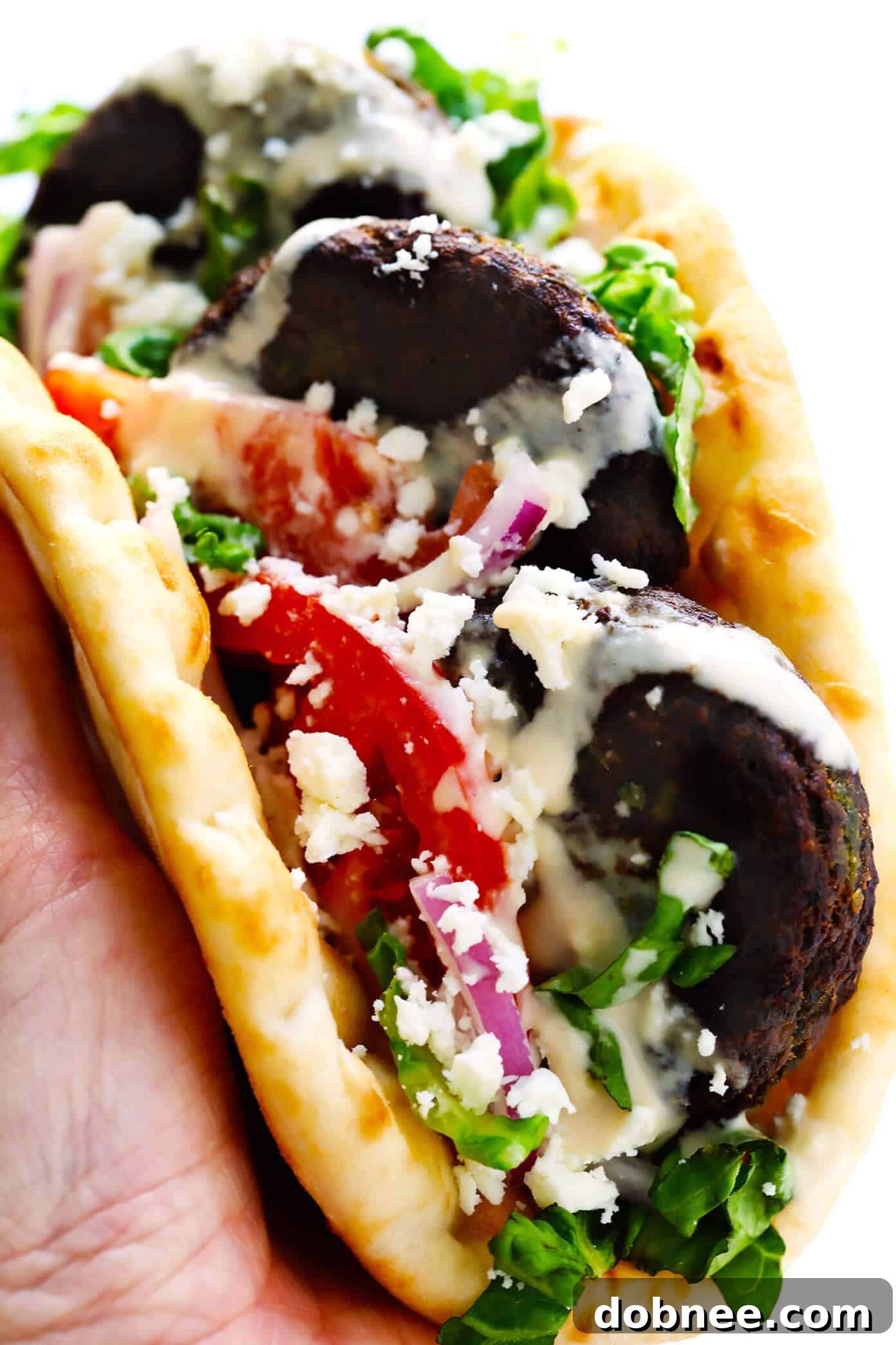 A Fresh Homemade Falafel Wrap with crisp vegetables and sauce.