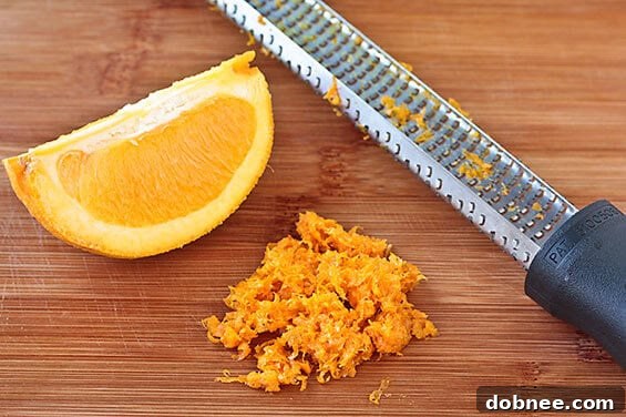 Slice of Orange Ricotta Pound Cake showing its moist crumb, topped with fresh strawberries