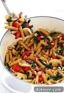 Pasta with Mushrooms, Tomatoes & Spinach – an easy, quick, and healthy vegetarian pasta recipe with a simple white wine sauce. Perfect for weeknights!