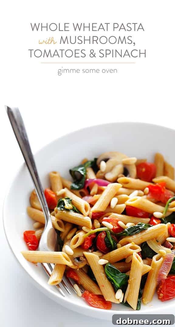A top-down view of the delicious Pasta with Mushrooms, Tomatoes and Spinach, ready to be served. This easy, healthy, and quick recipe is perfect for a satisfying meal. | dobnee.com