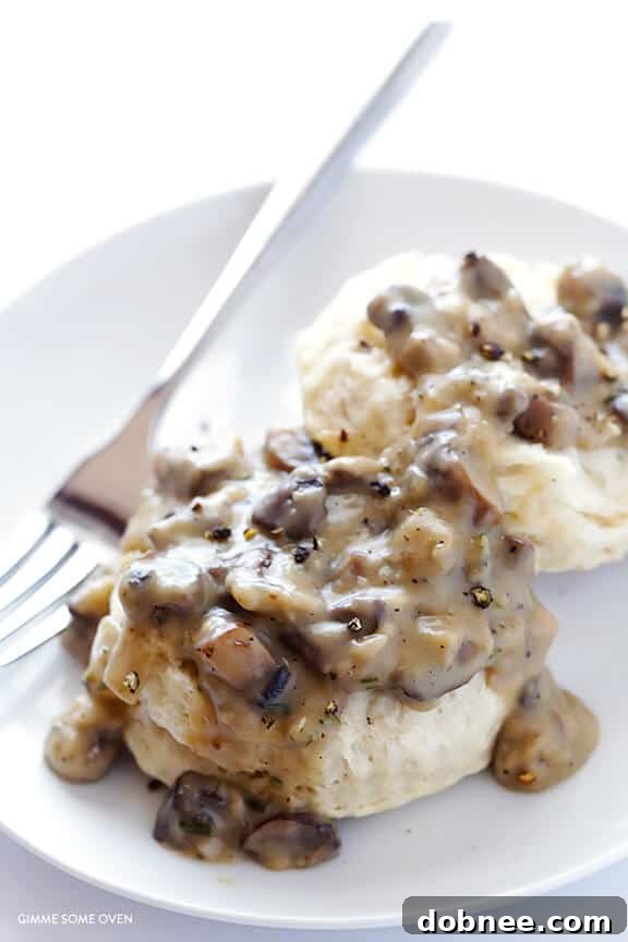 Close-up of fluffy vegan biscuits drenched in creamy mushroom gravy.