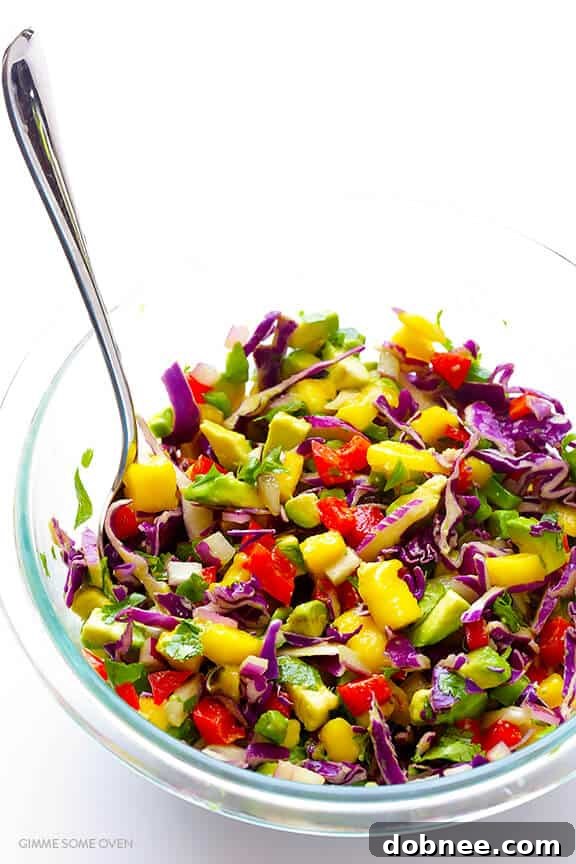 Kaleidoscope Fish Taco Nachos 5 Melted cheese over blue corn tortilla chips, forming the base for Rainbow Fish Taco Nachos.