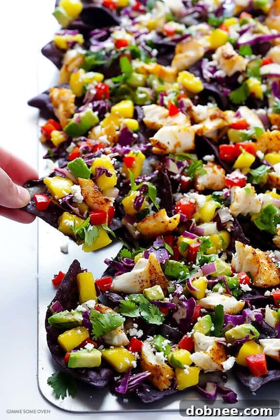 Kaleidoscope Fish Taco Nachos 7 Diced mango, red onion, bell pepper, and cilantro being mixed for the rainbow mango slaw.