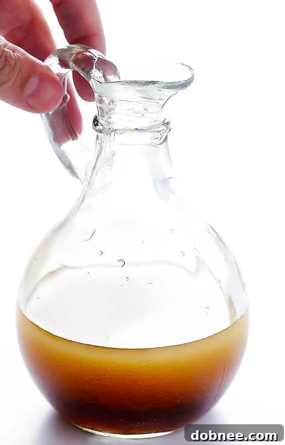 Separated ingredients for the Easy Asian Quinoa Salad including shredded cabbage, carrots, green onions, almonds, and cooked quinoa.