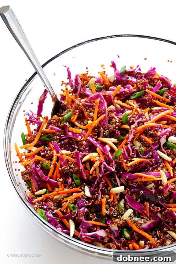 The fully mixed Easy Asian Quinoa Salad, tossed with vinaigrette and topped with sesame seeds, ready to serve.