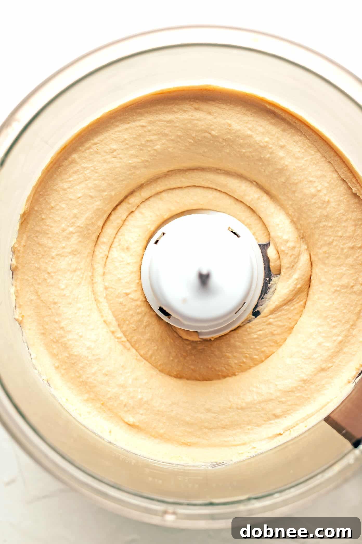 Homemade hummus served with fresh vegetables and pita bread for a healthy snack.