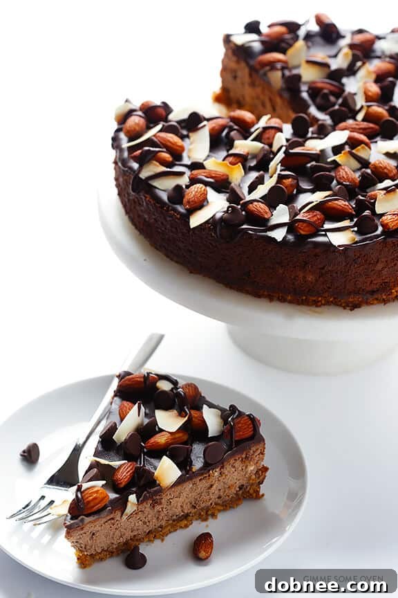 Almond Joy Cheesecake with a gluten-free almond crust and chocolate, almond, and coconut toppings.